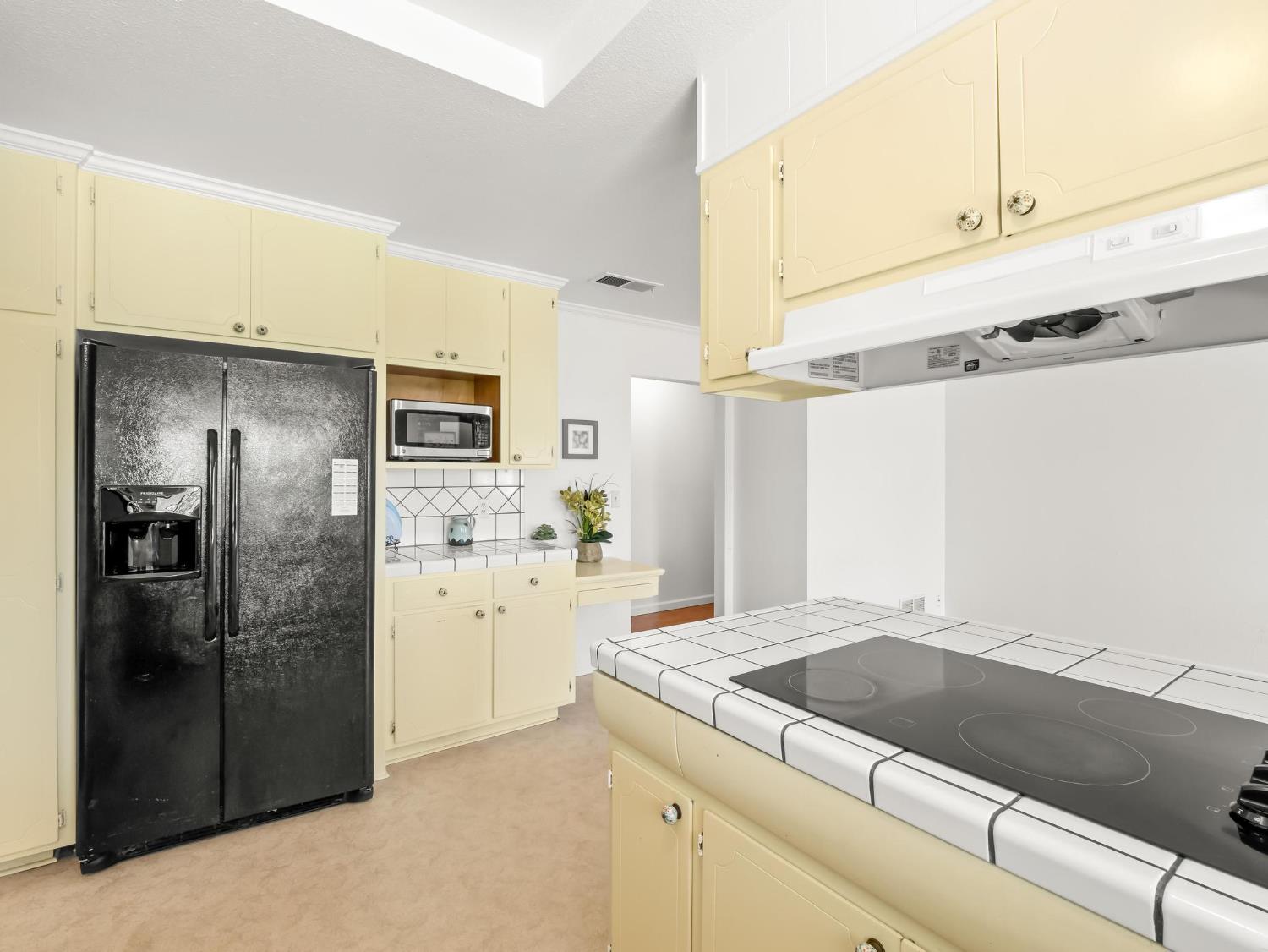 873 Cedar Lane Lemoore, CA 93245 - Photo 23 of 41 a kitchen with a refrigerator and a sink