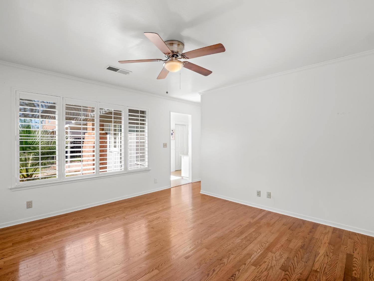 873 Cedar Lane Lemoore, CA 93245 - Photo 26 of 41 a view of an empty room with wooden floor and a window