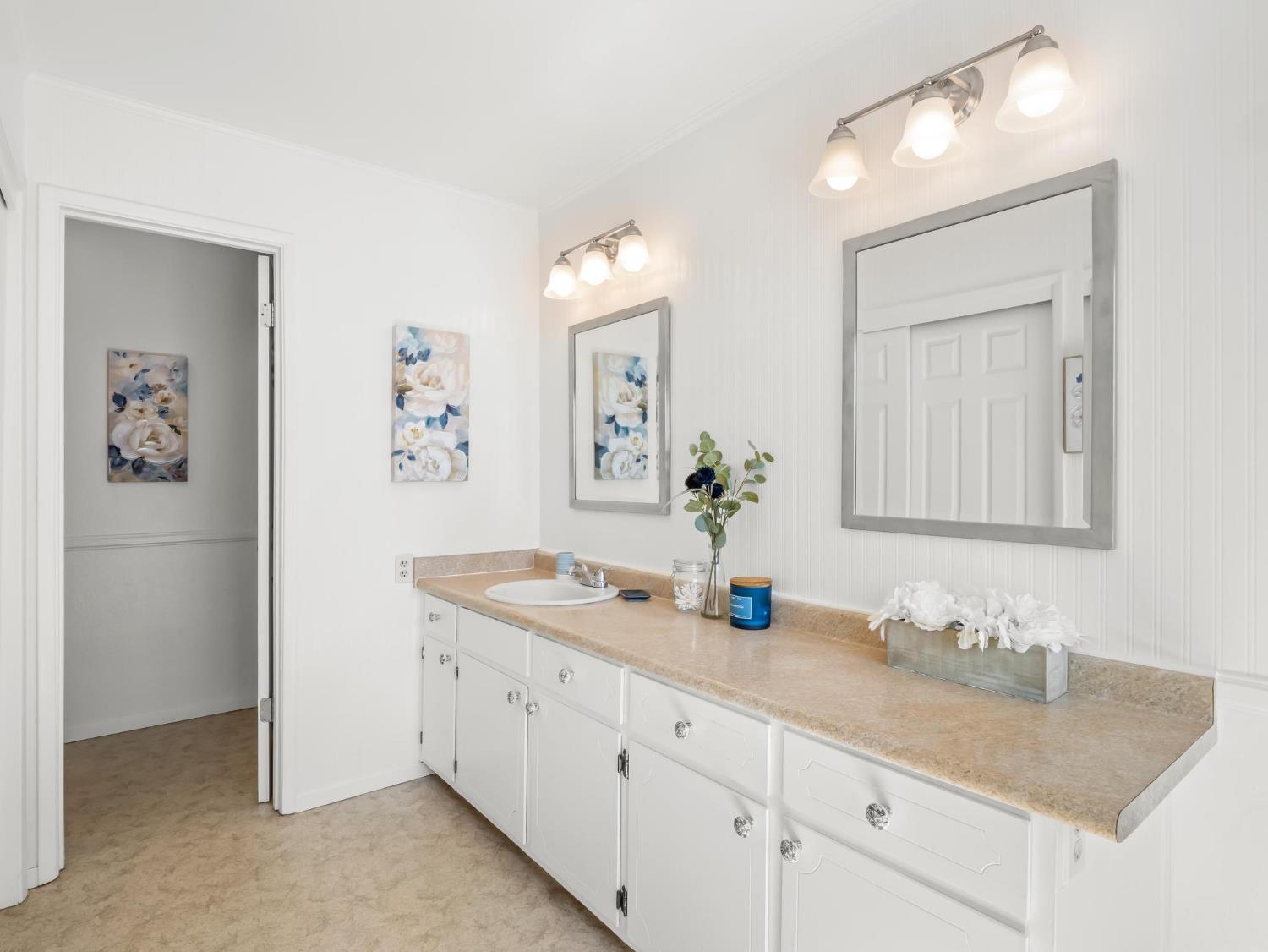 873 Cedar Lane Lemoore, CA 93245 - Photo 29 of 41 a bathroom with double sink and a mirror
