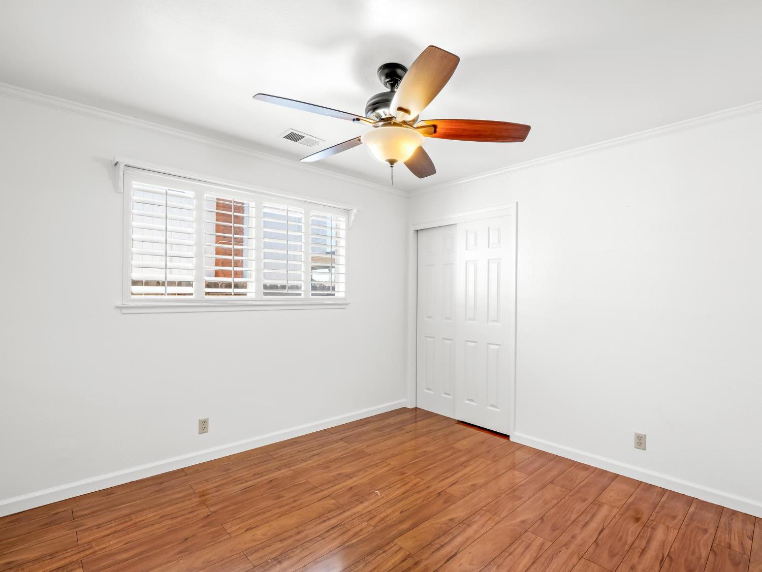 873 Cedar Lane Lemoore, CA 93245 - Photo 33 of 41 a view of empty room with wooden floor and fan