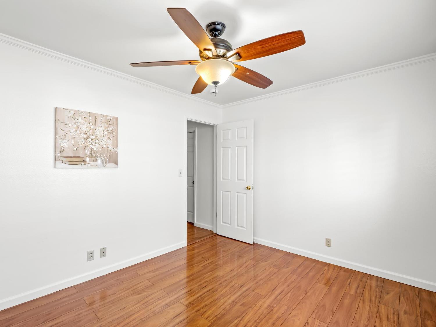 873 Cedar Lane Lemoore, CA 93245 - Photo 36 of 41 an empty room with wooden floor and ceiling fan