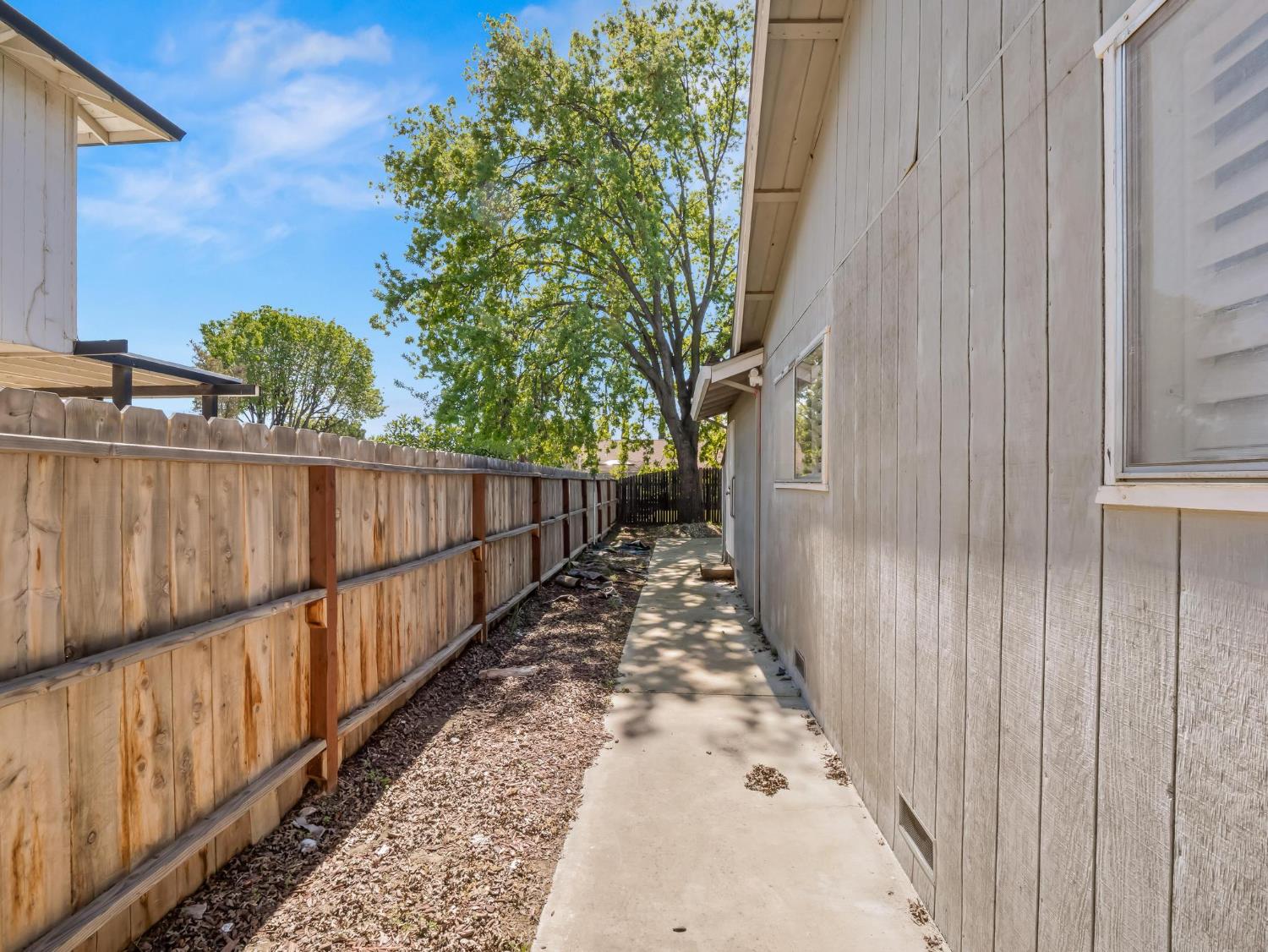 873 Cedar Lane Lemoore, CA 93245 - Photo 40 of 41 a view of a pathway with a wrought fence