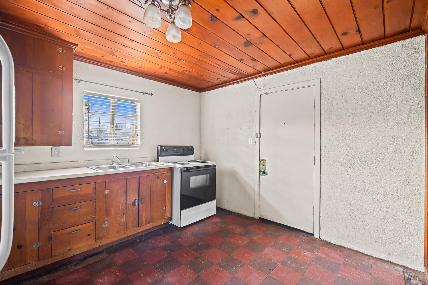 2124 29th Street, Unit REAR Lubbock, TX 79411 - Photo 2 of 10 a kitchen with stainless steel appliances granite countertop a sink and cabinets with wooden floor