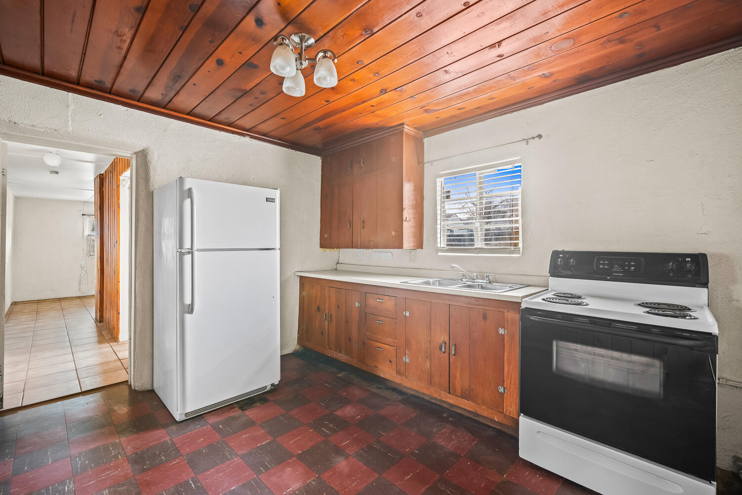 2124 29th Street, Unit REAR Lubbock, TX 79411 - Photo 3 of 10 a kitchen with a stove top oven and refrigerator
