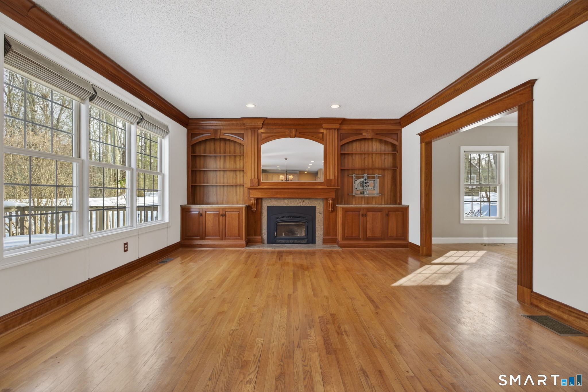 149 Ford Road Woodbridge, CT 06525 - Photo 17 of 47 FAMILY ROOM WITH CUSTOM BUILT-INS & WOOD STOVE INSERT IN FIREPLACE