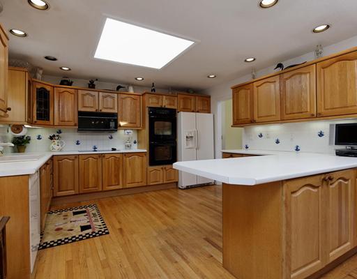 242 Pemberwick Road Greenwich, CT 06831 - Photo 4 of 10 a kitchen with stainless steel appliances kitchen island granite countertop a sink refrigerator and cabinets