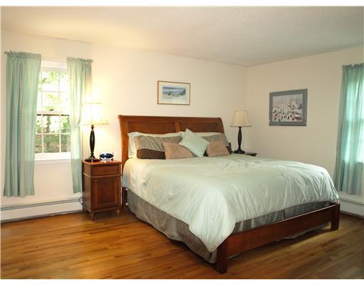242 Pemberwick Road Greenwich, CT 06831 - Photo 6 of 10 a bedroom with a bed and wooden floor