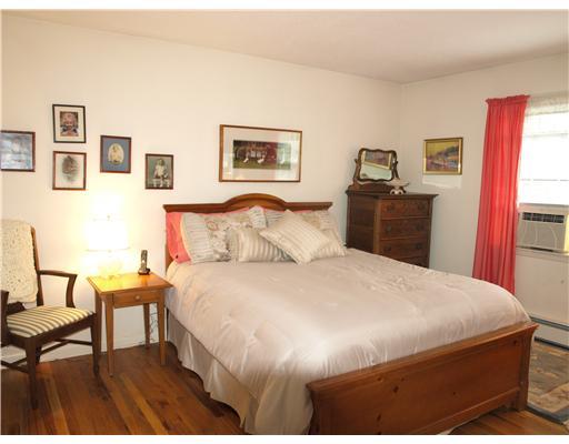242 Pemberwick Road Greenwich, CT 06831 - Photo 8 of 10 a bedroom with a bed and wooden floor