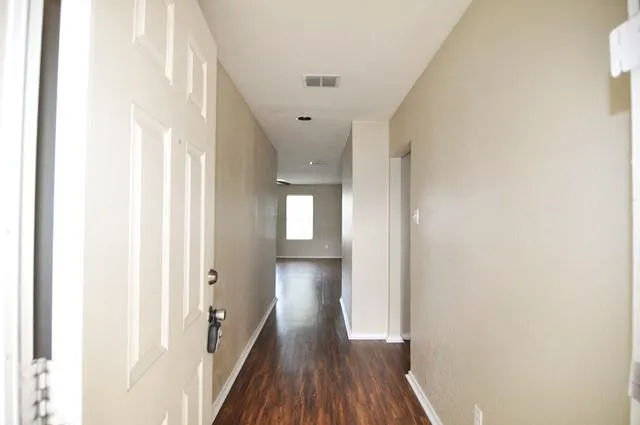 a view of hallway with wooden floor