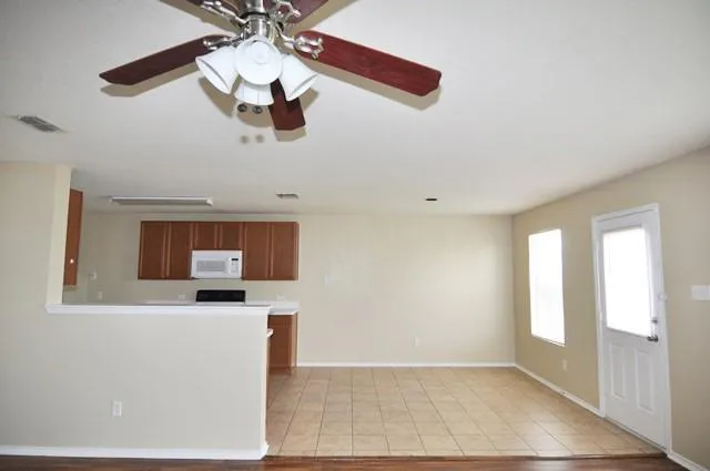 a kitchen with stainless steel appliances a microwave a stove and white cabinets
