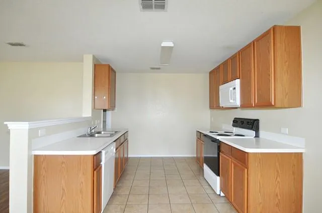 a kitchen with a sink cabinets and appliances