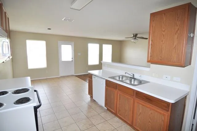 a kitchen with a sink cabinets and window