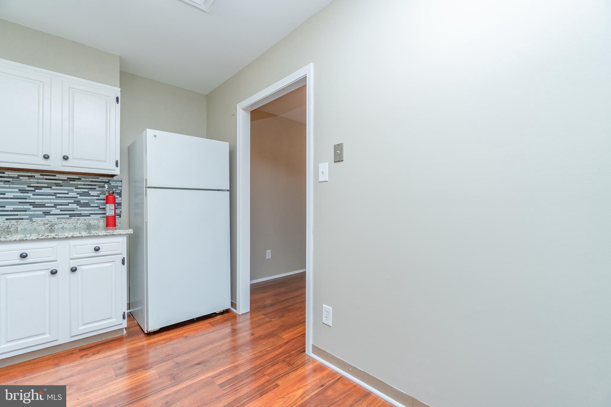 411 Conestoga Road, Unit 22 Devon, PA 19333 - Photo 16 of 27 a utility room with wooden floor washer and dryer