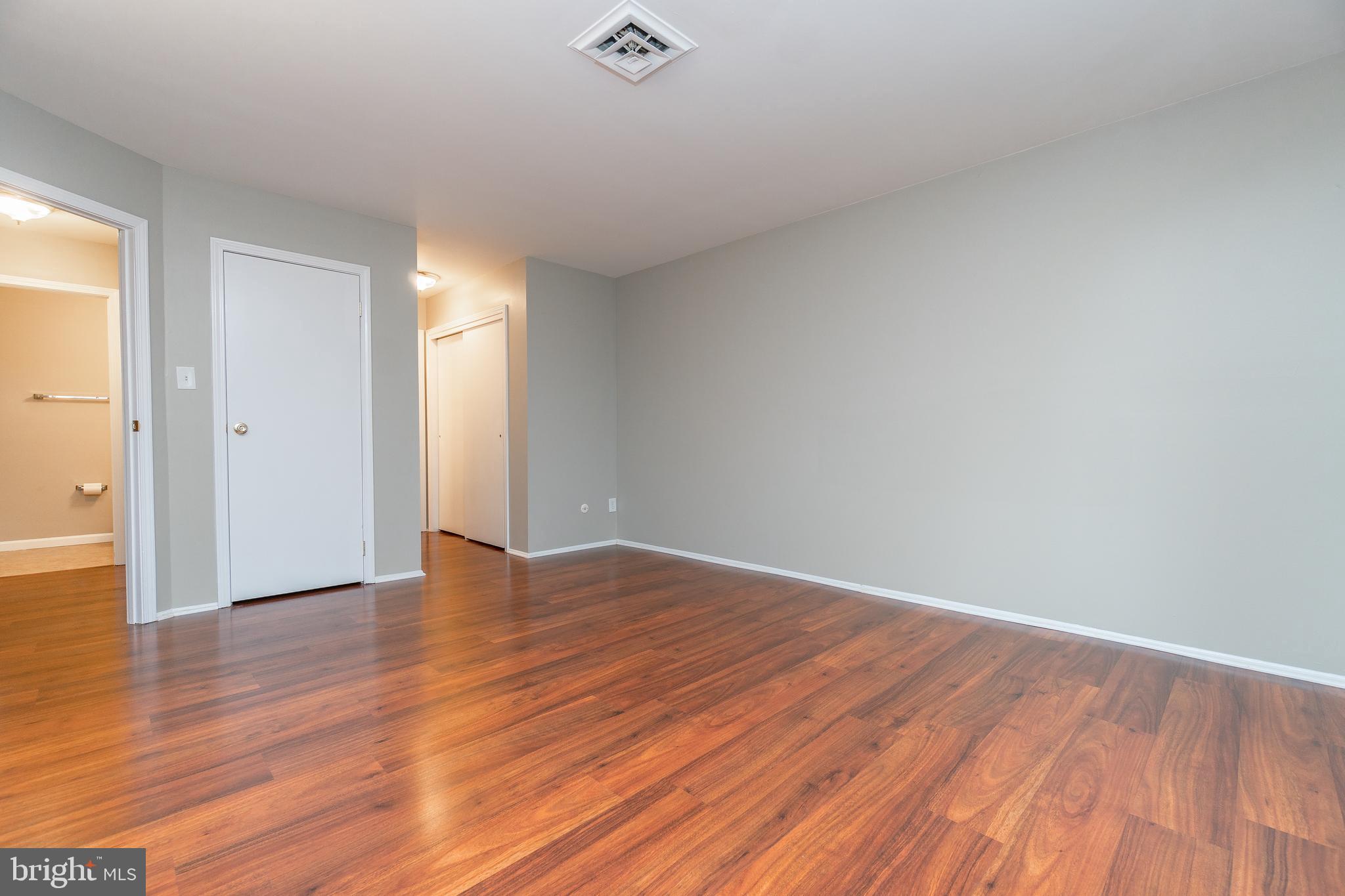 411 Conestoga Road, Unit 22 Devon, PA 19333 - Photo 18 of 27 a view of an empty room with wooden floor and a window