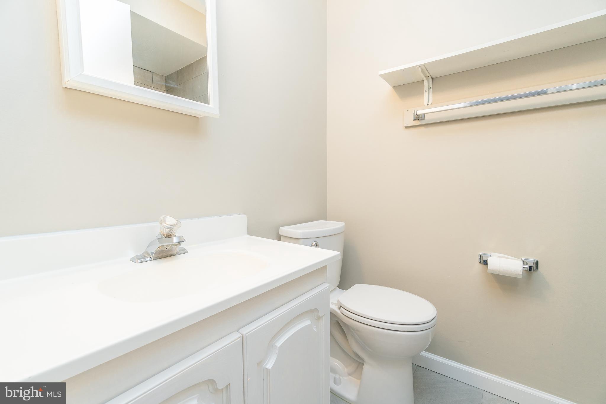 411 Conestoga Road, Unit 22 Devon, PA 19333 - Photo 22 of 27 a bathroom with a sink a toilet and a mirror