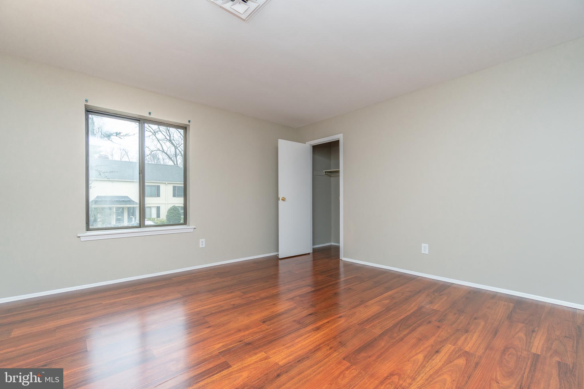 411 Conestoga Road, Unit 22 Devon, PA 19333 - Photo 23 of 27 a view of an empty room with wooden floor and a window