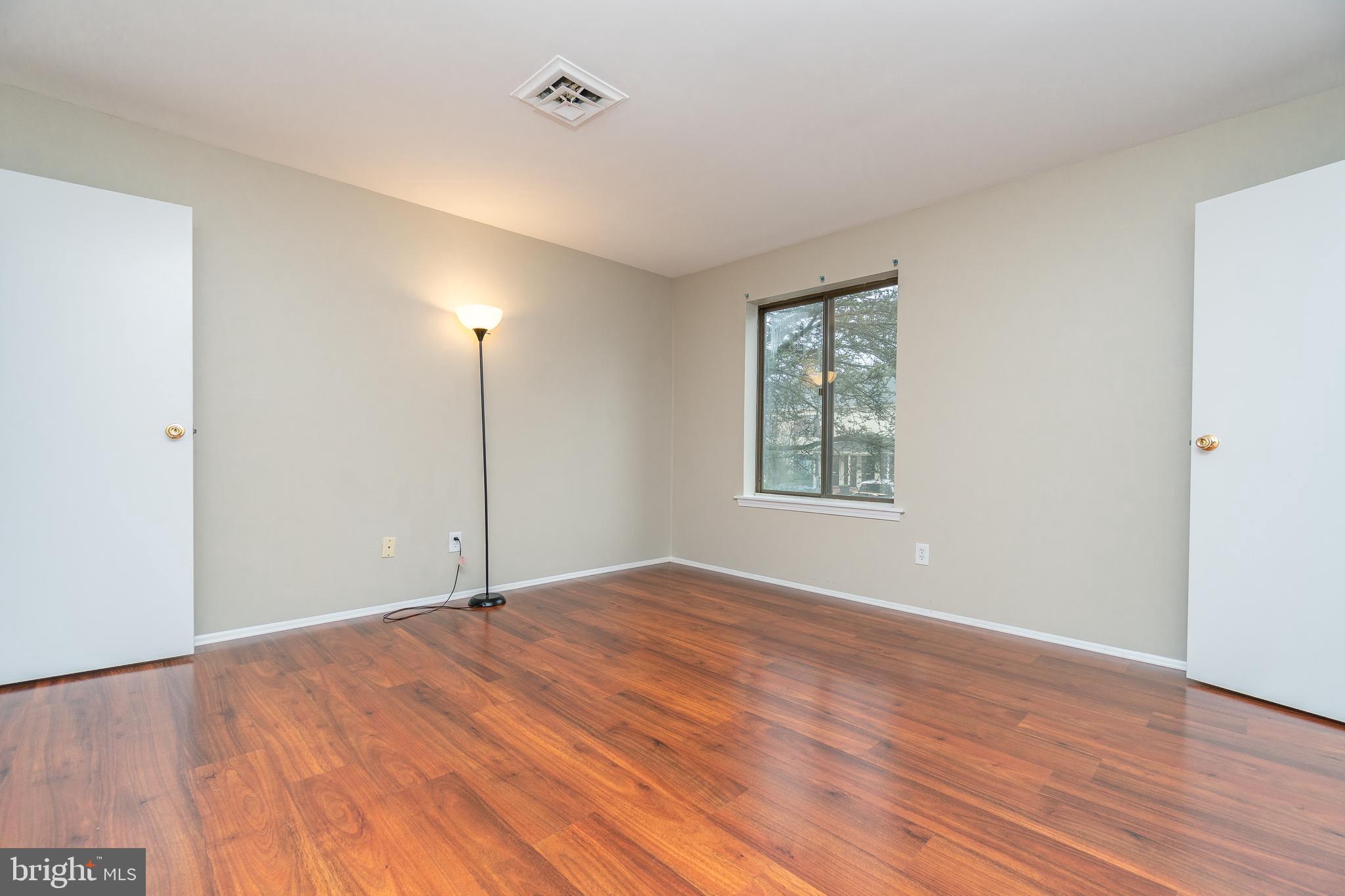 411 Conestoga Road, Unit 22 Devon, PA 19333 - Photo 26 of 27 a view of an empty room with wooden floor and a window
