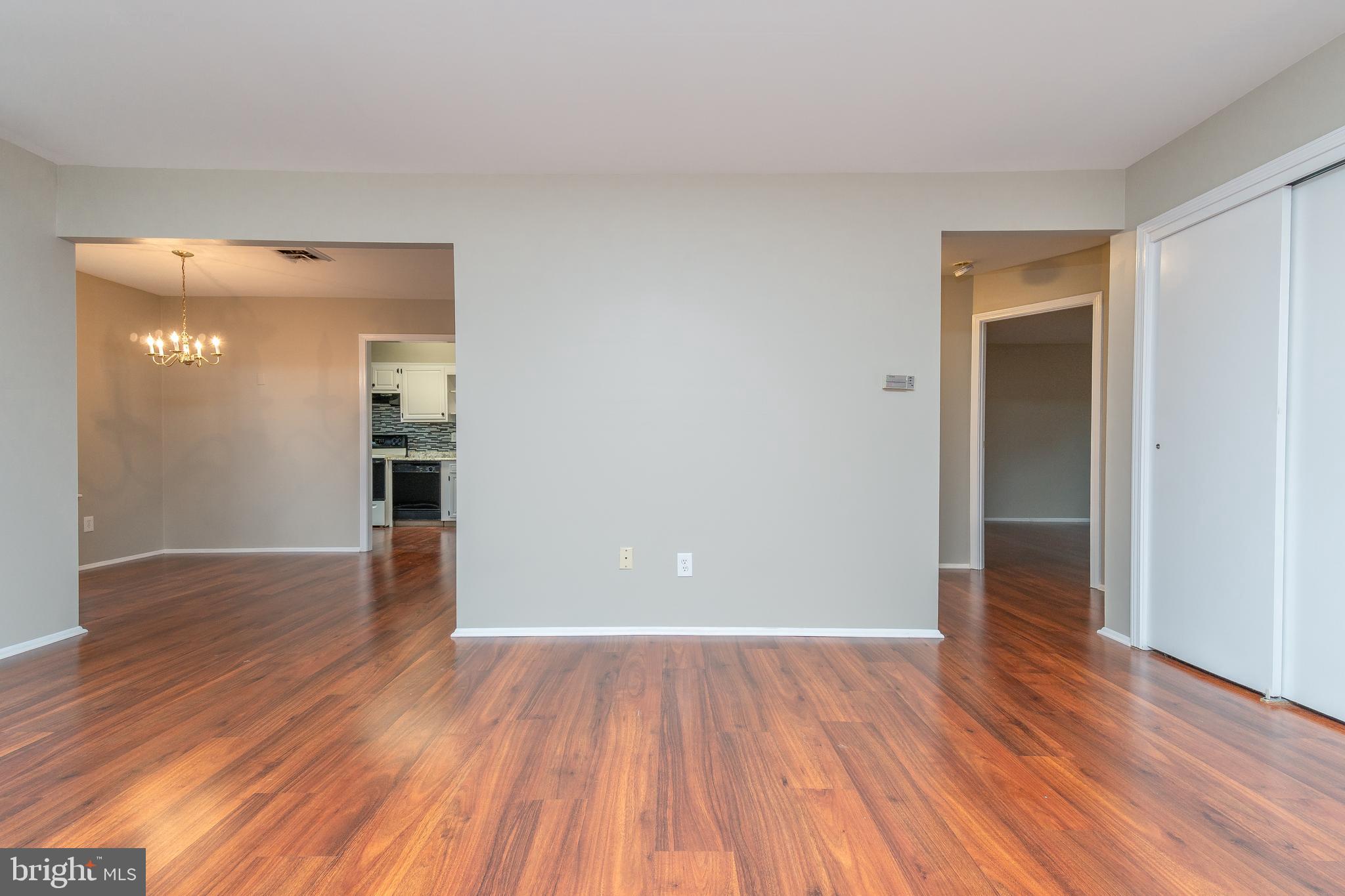 411 Conestoga Road, Unit 22 Devon, PA 19333 - Photo 9 of 27 a view of a hallway with wooden floor and a refrigerator