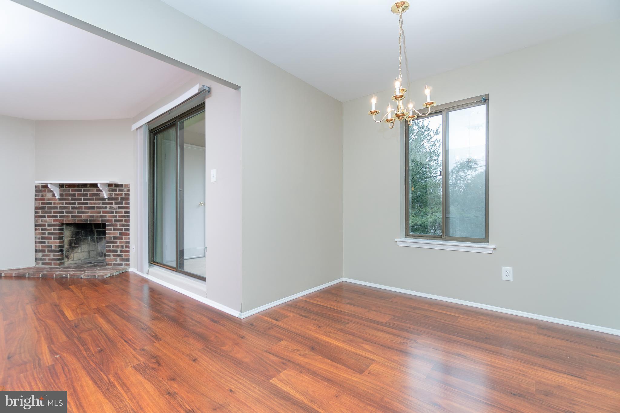 411 Conestoga Road, Unit 22 Devon, PA 19333 - Photo 10 of 27 a view of a livingroom with a chandelier fire place