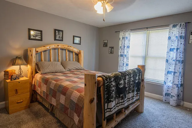 a bedroom with a bed and a chandelier