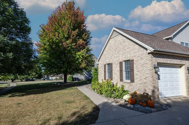 a front view of a house with a yard and a garage