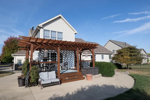 a view of house with outdoor space and sitting area