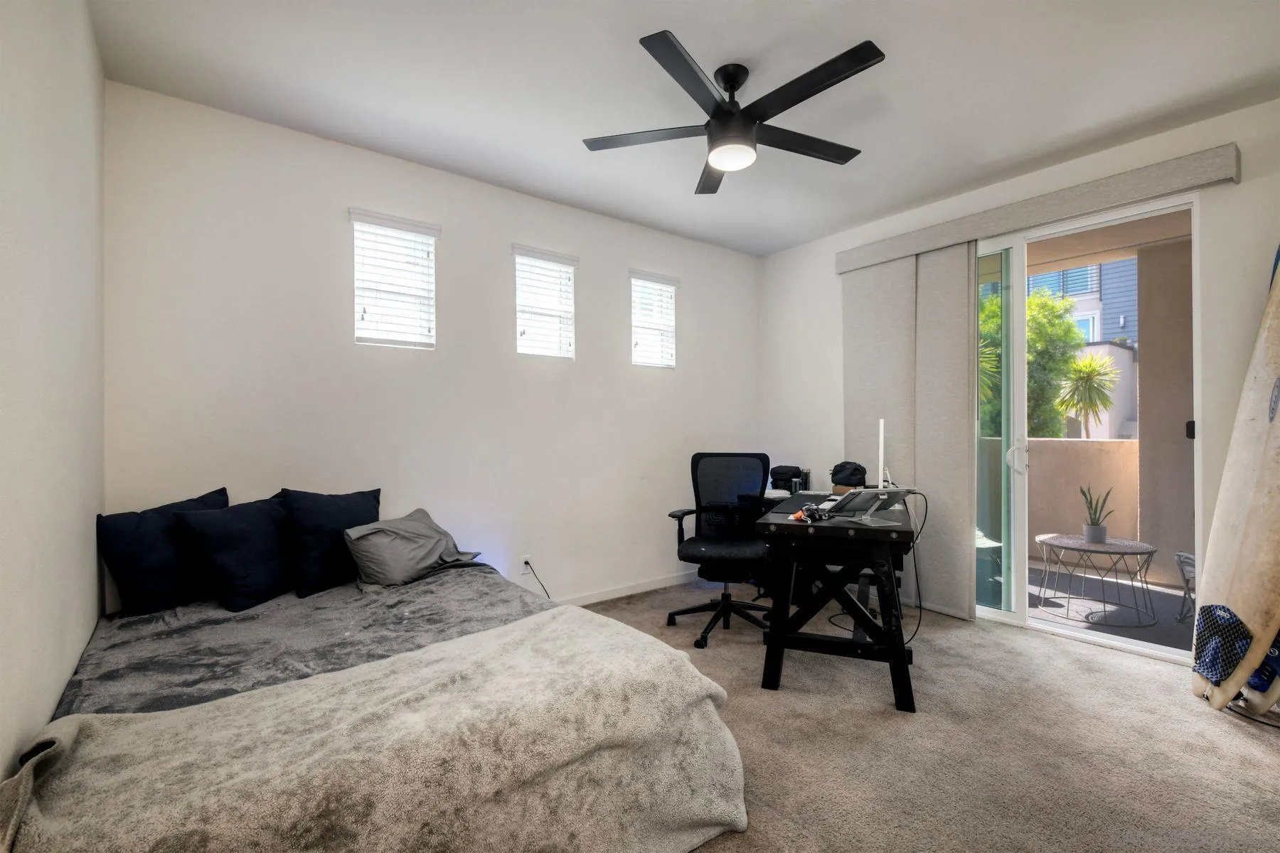6058 Colt Place, Unit 101 Carlsbad, CA 92009 - Photo 17 of 42 a bedroom with a bed and a desk