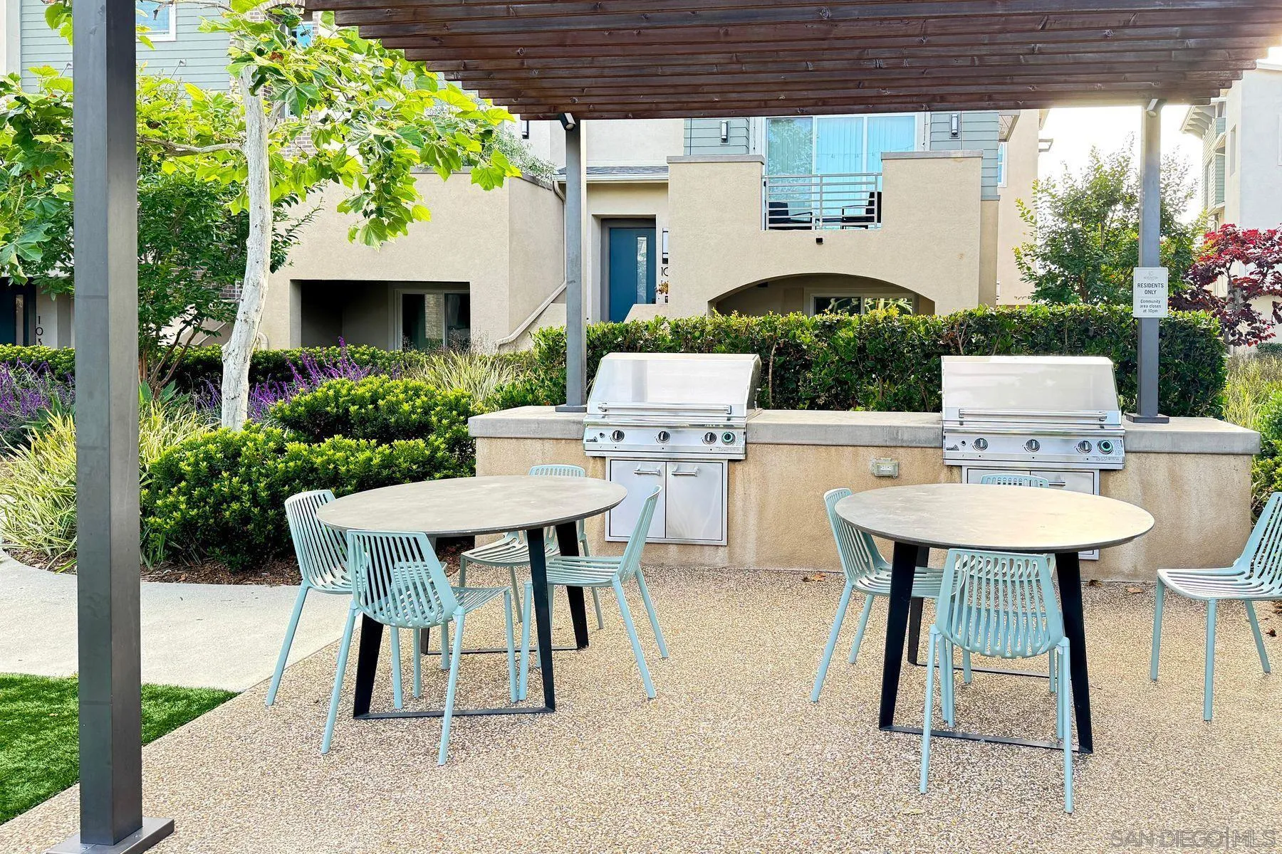 6058 Colt Place, Unit 101 Carlsbad, CA 92009 - Photo 26 of 42 a view of a patio with a table and chairs