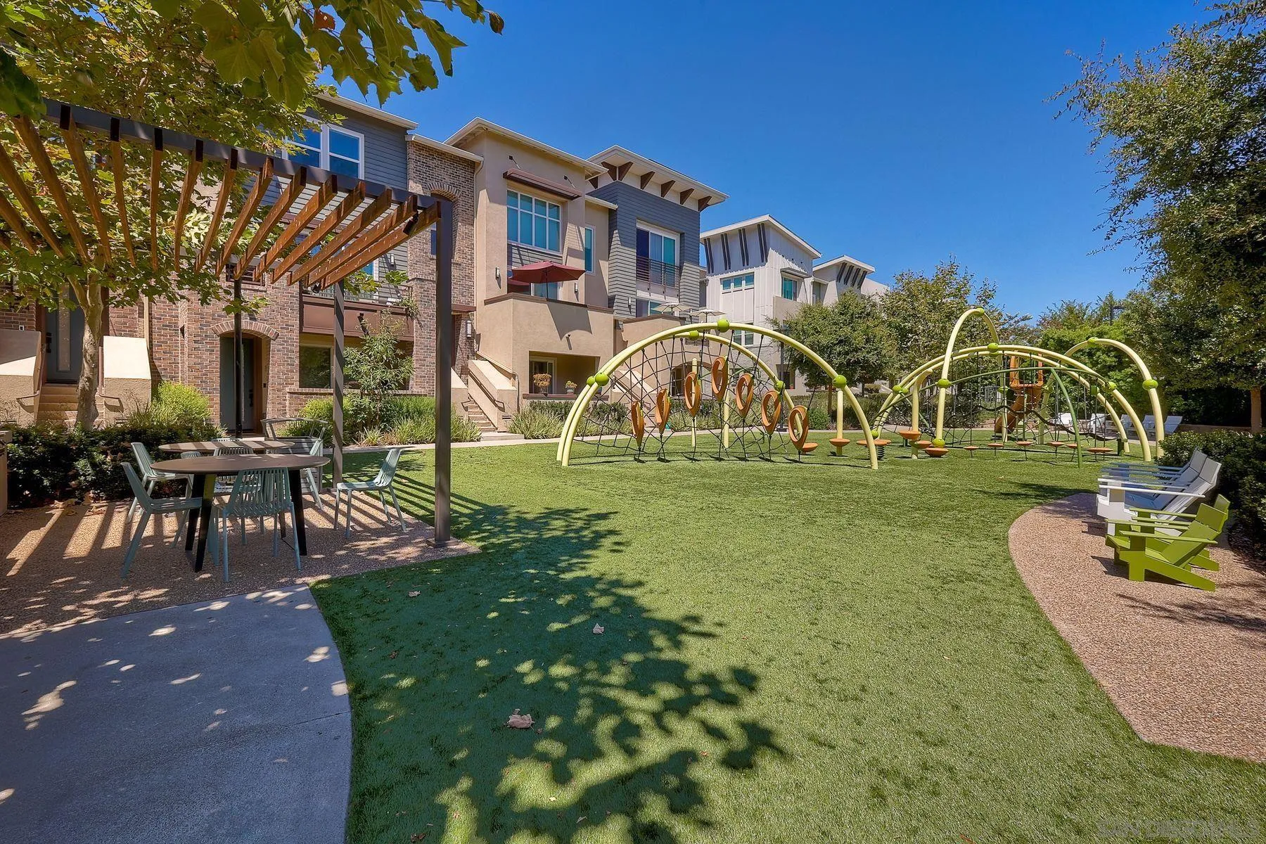 6058 Colt Place, Unit 101 Carlsbad, CA 92009 - Photo 30 of 42 a front view of a house with a garden