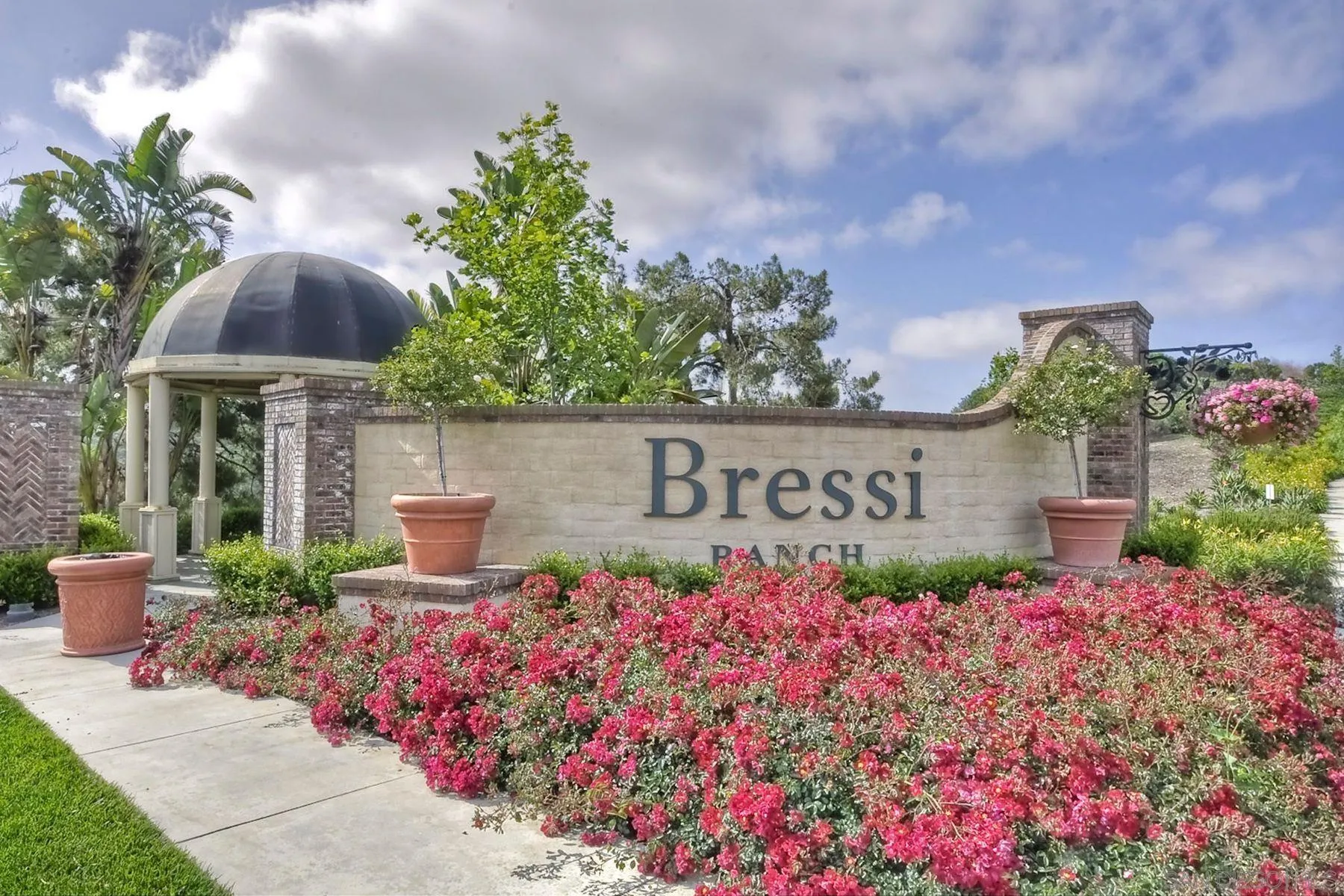 6058 Colt Place, Unit 101 Carlsbad, CA 92009 - Photo 32 of 42 a sign that is in front of flowers