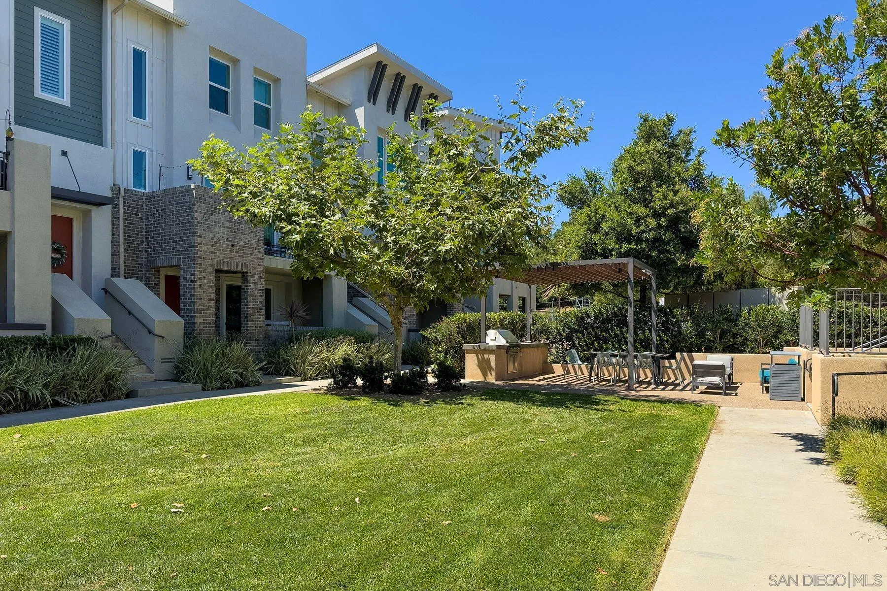 6058 Colt Place, Unit 101 Carlsbad, CA 92009 - Photo 39 of 42 a view of a house with a yard porch and sitting area
