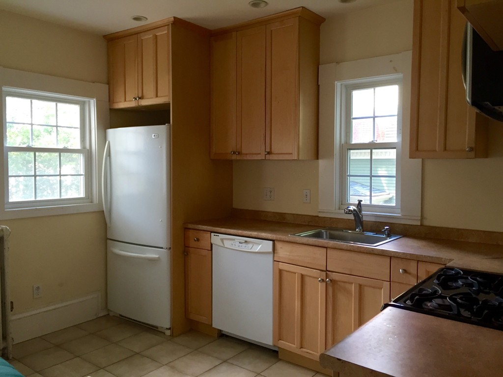 365 Harvard Street Cambridge, MA 02138 - Photo 11 of 15 a kitchen with stainless steel appliances granite countertop a refrigerator sink and cabinets