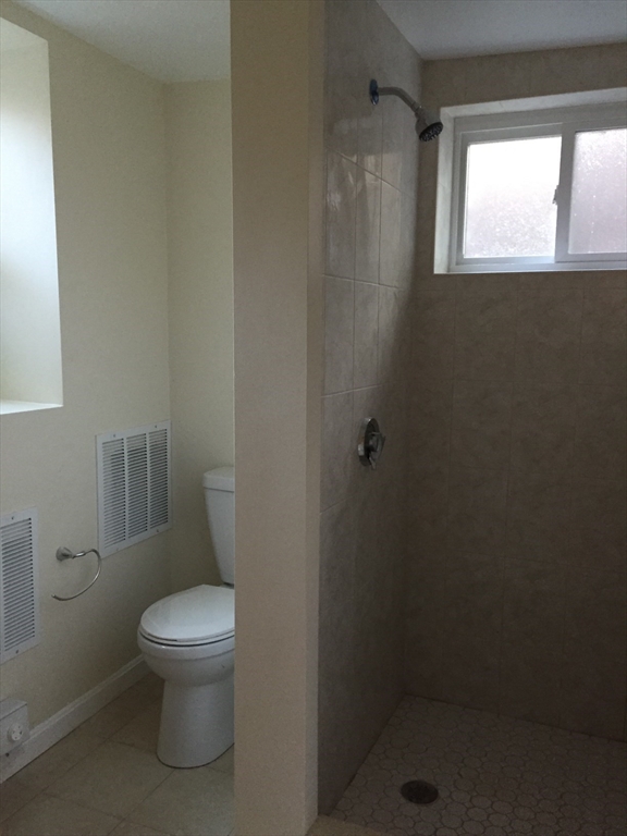 365 Harvard Street Cambridge, MA 02138 - Photo 14 of 15 a white toilet sitting next to a bathroom sink