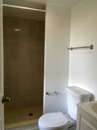 a bathroom with a toilet and a shower