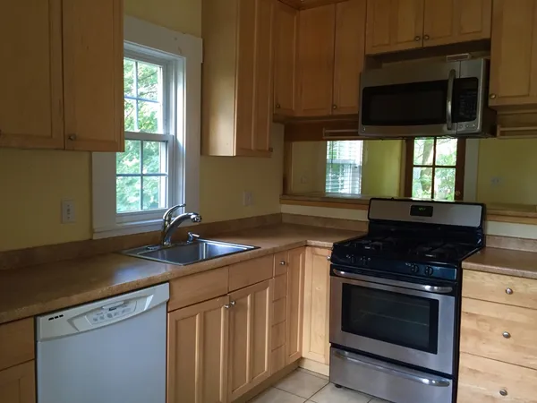 a kitchen with stainless steel appliances a stove sink and microwave