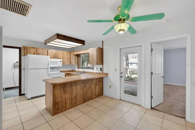 a kitchen with stainless steel appliances granite countertop a sink and a refrigerator