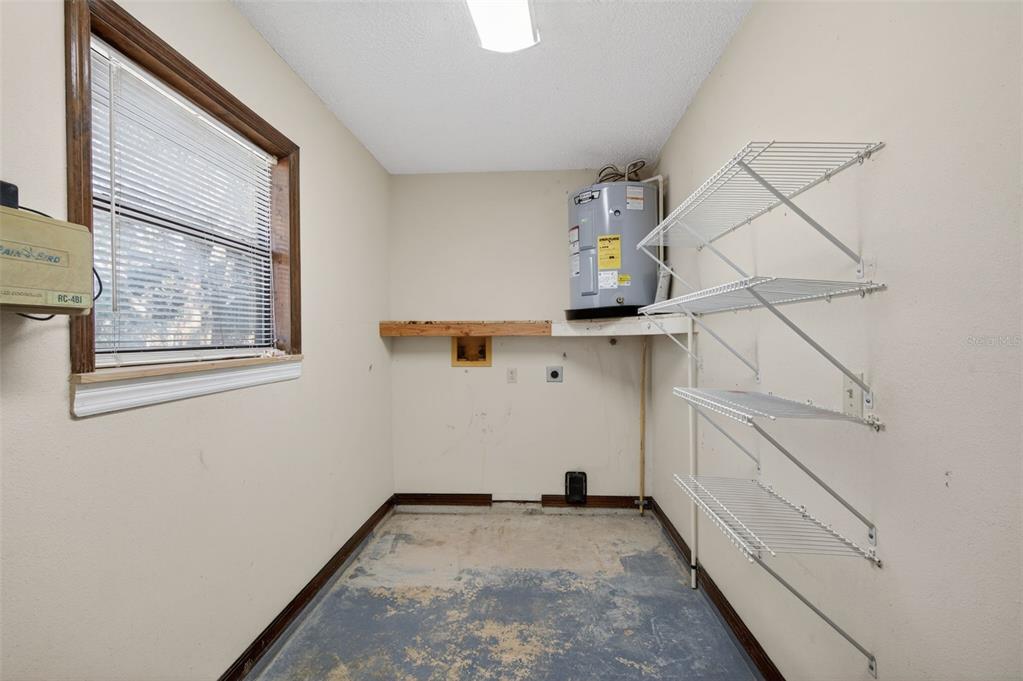 7157 Landmark Drive Spring Hill, FL 34606 - Photo 17 of 57 a view of storage and utility room with racks on the wall