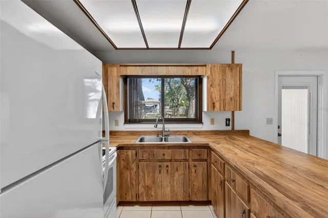 a kitchen with a sink a counter top space and cabinets