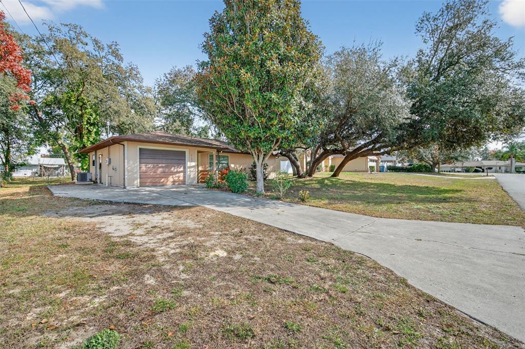 7157 Landmark Drive Spring Hill, FL 34606 - Photo 2 of 57 a front view of a house with a yard and garage