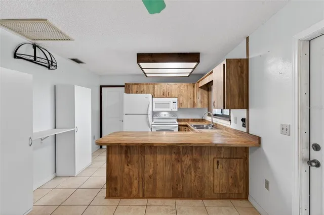 a kitchen with a sink and large window