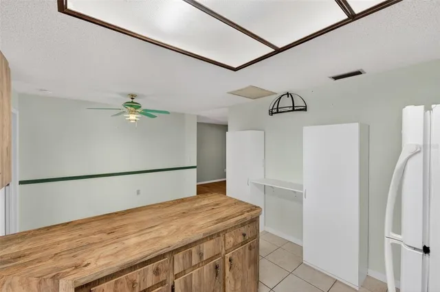 an empty room with a ceiling fan and wooden floor