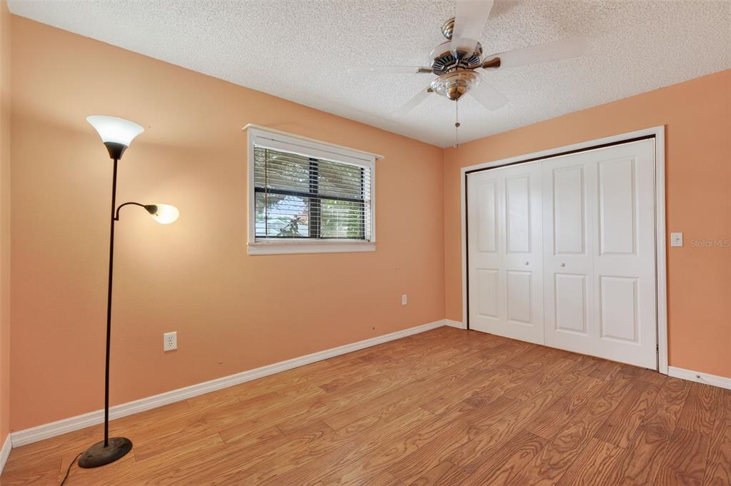 7157 Landmark Drive Spring Hill, FL 34606 - Photo 29 of 57 a view of an empty room with a ceiling fan and window