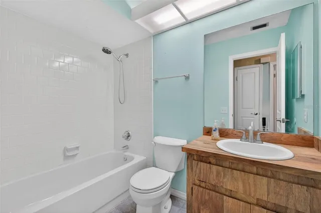 a view of a livingroom with a ceiling fan and window