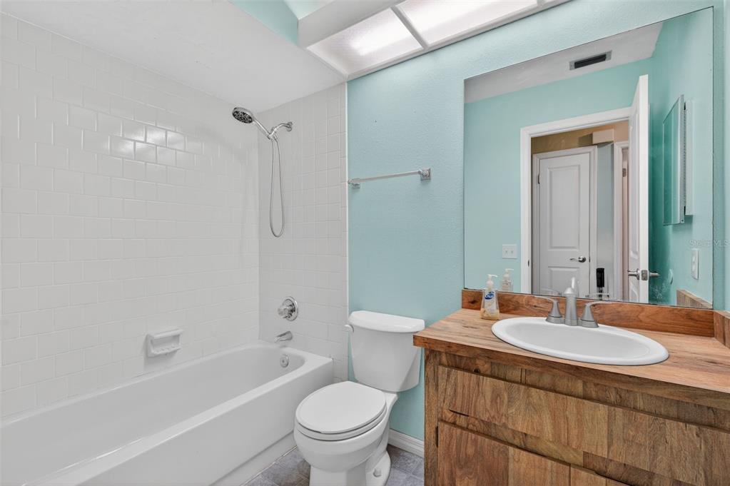 7157 Landmark Drive Spring Hill, FL 34606 - Photo 34 of 57 a bathroom with a granite countertop sink toilet and shower