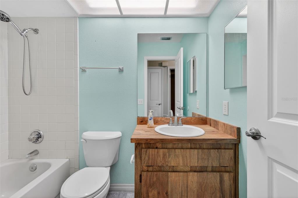 7157 Landmark Drive Spring Hill, FL 34606 - Photo 35 of 57 a bathroom with a sink and a mirror