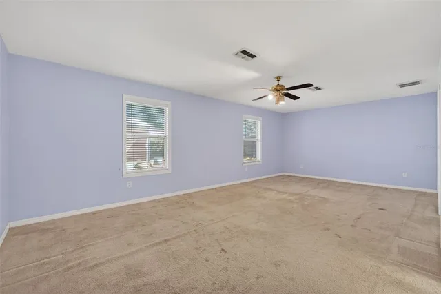 a bathroom with a granite countertop sink mirror vanity and toilet