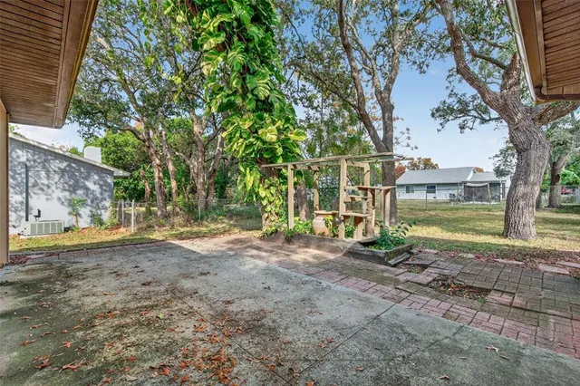a backyard of a house with yard and trampoline