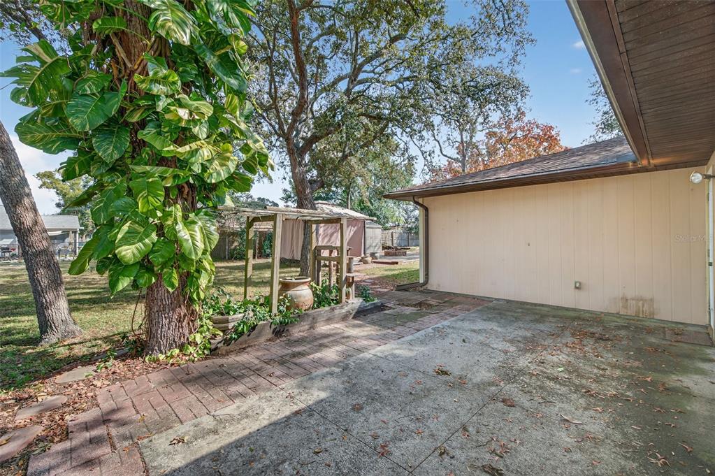 7157 Landmark Drive Spring Hill, FL 34606 - Photo 43 of 57 a backyard of a house with lots of green space