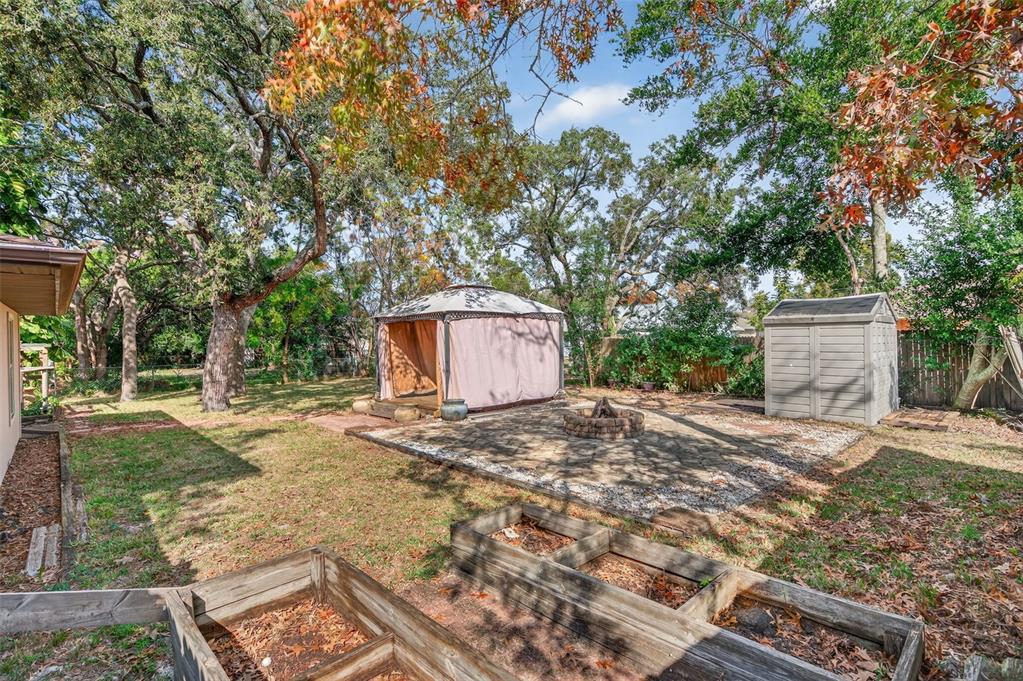 7157 Landmark Drive Spring Hill, FL 34606 - Photo 47 of 57 a big room with fountain and large trees