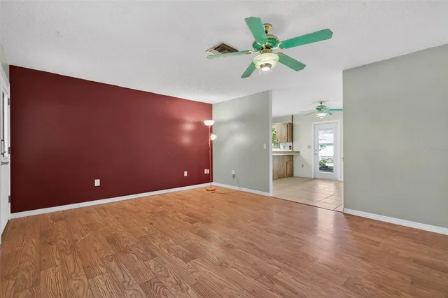 a view of an empty room with a ceiling fan
